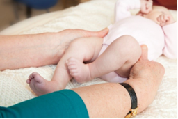 Photo of adult holding a baby's pelvis with both hands